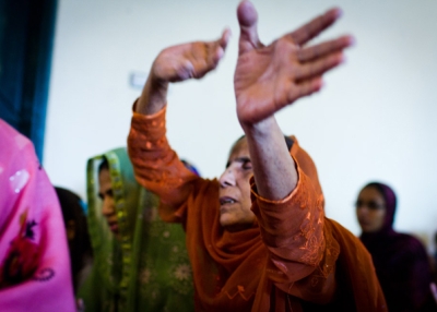 An elderly woman singing along with a Christmas carol at Dhala United Methodist Church, Lahore, Pakistan in December 2011. (Nushmia Khan)