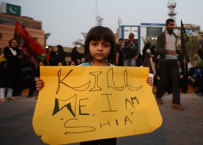 A Pakistani Shiite Muslim girl holds placard during a protest against the twin bombings in Quetta, in Karachi, Pakistan on January 13, 2013. (Asif Hassan/AFP/Getty Images)