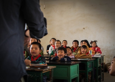 A classroom full of children smile and listen attentively to their teacher in Jizushan, Yunnan Province, China on March 6, 2013. (James Moallem)