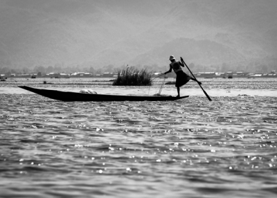 A fisherman balances precariously while rowing with his legs in Nyaung Shwe, Myanmar on May  9, 2013. (Fabio/Flickr)
