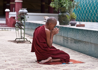 A monk pauses for a moment of prayer in Myanmar on September 7, 2013. (East.Lucky/Flickr)