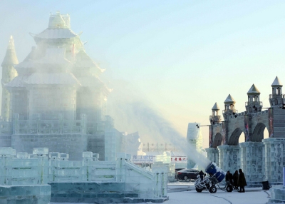 In preparation for China's Ice and Snow World, a snow-making machine covers a sculpture with artificial snow in Harbin, China on January 4, 2014. (Goh Chai Hin/AFP/Getty Images)