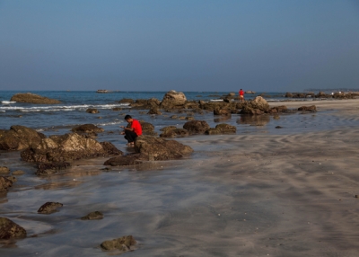 Tourists search for shells on the untouched Ngwe Saung Beach in Yangon, Burma on January 26, 2014. (Lauren DeCicca/Getty Images)