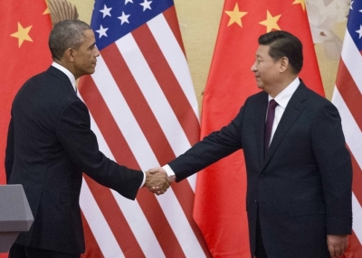 U.S. President Barack Obama (L) and China's President Xi Jinping reach out to shake hands following a bilateral meeting at the Great Hall of the People in Beijing on November 12, 2014. (Mandel Ngan/Getty Images)