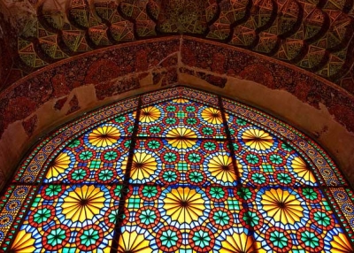 Sunshine lights up an intricate multi-colored stained glass window in Iran on April 29, 2015. (Luca Cerabona/Flickr)