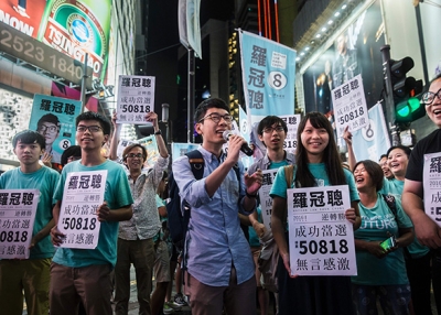 Nathan Law (C) speaks at a rally with Jousha Wong (centre L) and supporters in Causeway bay following Nathan Law's win in the Legislative Council election in Hong Kong on September 5, 2016. (Isaac Lawrence/AFP/Getty Images)