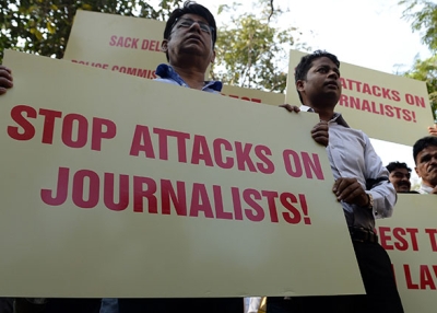 On February 17, 2016, Indian journalists shout slogans during a protest to condemn an assault on fellow media workers by lawyers at a court in New Delhi. (Indranil Mukherjee/AFP/Getty Images)