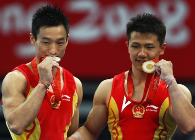 Chinese gymnasts pose with their medals at the 2008 Olympic Games in Beijing. (Jonathan Ferrey/Getty)