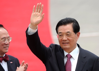 Chinese President Hu Jintao (R) waves to the press as Hong Kong Chief Executive Donald Tsang claps after arriving at Hong Kong's International airport on June 29, 2012. (Dale de la Rey/AFP/GettyImages)