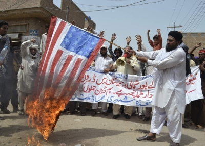 An activist of Muttahida Sheri Mahaz burns US flag during a protest in Multan on July 7, 2012, against a recent US drone attack. (S S Mirza/AFP/GettyImages)