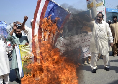 A Pakistani United Citizen Action demonstrator holds a burning US flag during a protest in Multan on October 25, 2012 against the US drone attacks in Pakistani tribal areas. (S.S. Mirza/AFP/Getty Images)