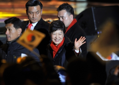 South Korea's president-elect Park Geun-Hye waves to supporters as she arrives to deliver a victory speech on a stage in the centre of Seoul on December 19, 2012. (Jung Yeon-Je/AFP/Getty Images)