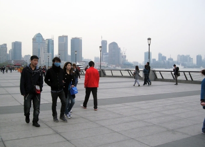 Despite public concern about the emergence of H7N9 bird flu in Shanghai, only a handful of pedestrians walking along the waterfront Bund on April 8, 2013 chose to don face masks. (Maura Elizabeth Cunningham)