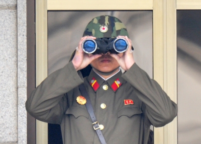A North Korean soldier using binoculars watches from his quarters at the truce village of Panmunjom in the demilitarized zone on April 23, 2013. (Kim Jae-Hwan/AFP/Getty Images)