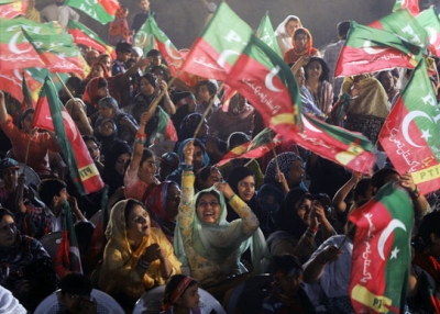 Supporters of Pakistan Tehreek-e-Insaaf (PTI) or the "Movement for Justice" party wave party flags at the election campaign in Lahore on May 5, 2013.  A roadside bomb exploded at an election rally in southwest Pakistan the same day, killing two people, officials said as violence continued ahead of historic polls on May 11.  (Arif Ali/AFP/Getty Images) 