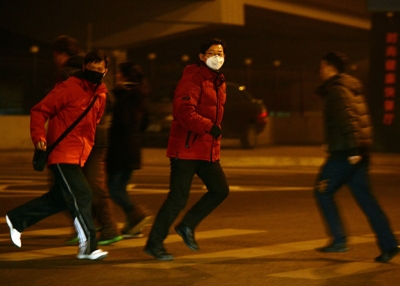 Commuters cross a Beijing street in heavy air pollution, January 30, 2013. On this day, when PM2.5 readings reached a high of 315, according to measurements taken by the U.S. Department of State, Beijing officials urged people to stay indoors. (Mark Ralston/AFP/Getty Images)