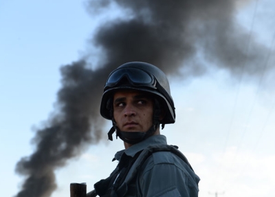 An Afghan policeman stands guard at the site of a suicide attack in Kabul on July 2, 2013. (Shah Marai/AFP/Getty Images) 