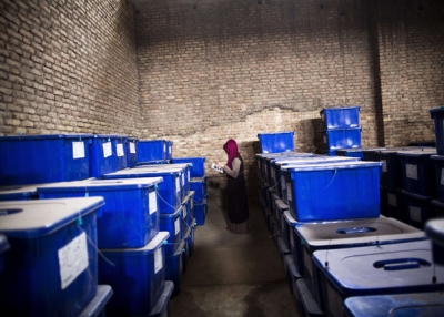 Afghan election employee, Forouzan Barez checks the plastic boxes containing election material at a warehouse prior to transportation to the polling centers, in the northwestern city of Herat on April 3, 2014. (Behrouz Mehri/AFP/Getty Images)