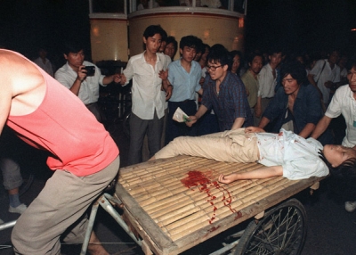 A girl wounded during the clash between the army and students on June 4, 1989 near Beijing's Tiananmen Square is carried out by a cart. (Manuel Ceneta/AFP/Getty Images)