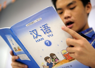 Student reads from a Chinese language textbook. (Adek Berry/Getty)