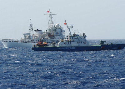 A China Coast Guard ship (L) chases a Vietnam Coast Guard vessel near the site of a Chinese drilling oil rig being installed at the disputed water in the South China Sea off Vietnam's central coast. (Photo credit should read Hoang Dinh Nam/AFP/Getty Images)