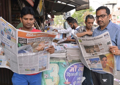 Two men in Amritsar, India read newspapers on April 26, 2015. (Narinder Nanu/AFP/Getty Images)