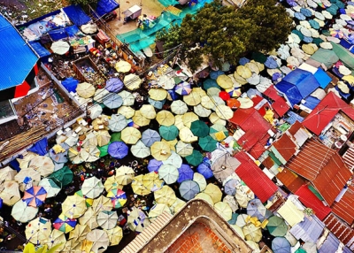 Vendors under umbrellas sell food at a market in Phnom Penh, Cambodia. (Roberto Trombetta/Flickr)