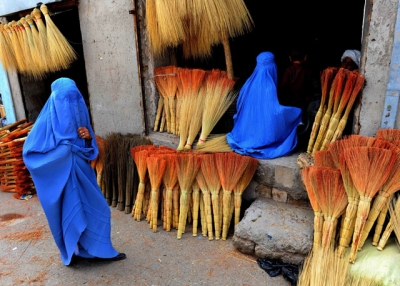 Afghan shoppers look for brooms at a roadside shop in Herat on April 9, 2014. (Aref Karimi/AFP/Getty Images)