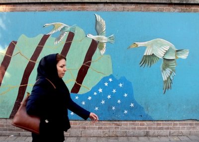 An Iranian woman walks past a mural on the wall of the former U.S. embassy in the Iranian capital Tehran on November 9, 2016. (Atta Kenare/AFP/Getty Images)