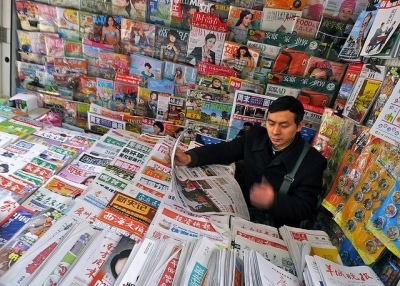 Catching up with the morning's headlines in a stall in Guangzhou, China on March 24, 2012. (r s gould/Flickr)