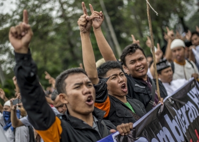 Indonesian Muslims gesture and shout slogans during an anti-government rally in Jakarta on July 18, 2017