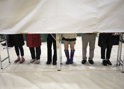 Japanese voters fill in their ballot papers at a polling station to vote in Japan's general election in Tokyo on October 22, 2017. (Behrouz Mehri/AFP/Getty Images)