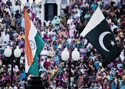 The flags of India and Pakistan are lowered simultaneously at the Wagah Border. The crowd on the Pakistani side of the border are pictured.