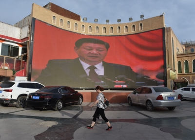 A video billboard of Xi Jinping overlooks Kashgar, China