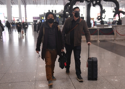 Wall Street Journal reporters Philip Wen (L) and Josh Chin (R) departing China in February