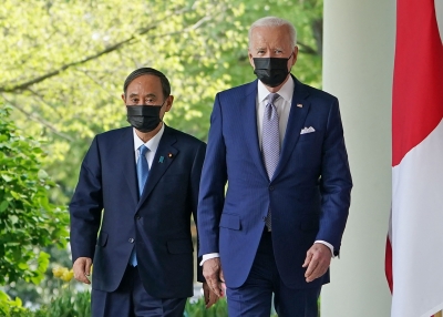 President Joe Biden and Japan's Prime Minister Yoshihide Suga walk through the Colonnade to take part in a joint press conference at the White House