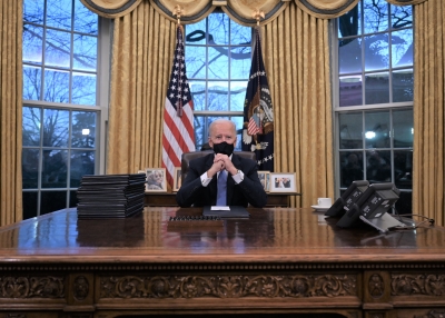 President Joe Biden sits in the Oval Office at the White House in January 2021