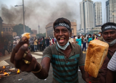A supporter of Sri Lanka's main opposition displays a loaf of bread to highlight the rising food prices during a protest against the economic crisis that brought fuel shortages and inflation in Colombo, Sri Lanka, on March 15, 2022.