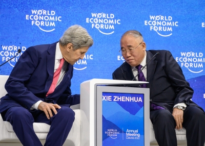 US climate envoy John Kerry (L) attends next to China's special climate envoy Xie Zhenhua during a session at the World Economic Forum annual meeting in Davos on May 24, 2022. 