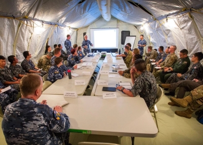 Royal Australian Air Force (RAAF), U.S. Air Force and Japanese Air Self-Defense Force (JASDF) personnel conduct a humanitarian assistance and disaster (HA/DR) relief briefing at Andersen Air Force Base, Guam, during Exercise Cope North 20 (CN20), a Pacific Air Forces-sponsored multilateral field training exercise. CN20 involves more than 2,000 personnel and approximately 100 aircraft and aims to increase the combat readiness and interoperability of the USAF, JASDF and RAAF.