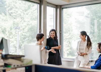 Relaxed businesswomen having a casual meeting by the window.
