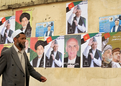 A man walks past posters of Aghan presidential candidates in Kabul on June 16, 2009. (Shah Marai/AFP/Getty Images)