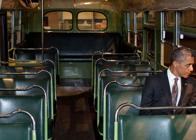 President Obama sits in Rosa Parks' seat on the same bus from her fateful ride.