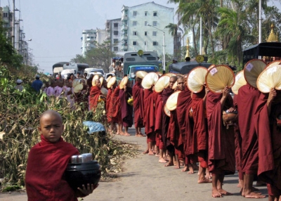 Buddhist monks make their way through the streets to collect offerings in Yangon on May 8, 2009, in the aftermath of Cyclone Nargis. (Hla Hla Htay/AFP/Getty Images)