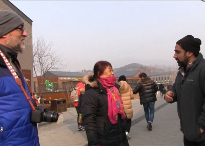 Greg Matza talks to a woman about visiting an older part of the Great Wall.