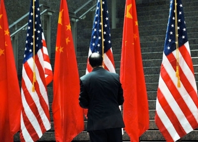 An official adjusts Chinese and US flags during the US-China Strategic and Economic Dialogue, held July 27, 2009 in Washington, DC. (Jewel Samad/AFP/Getty Images)