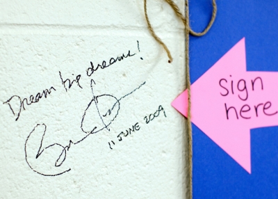 President Obama wrote "Dream big dreams!" on a school wall in Wisconsin.