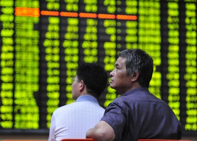 Investors watch the electronic board at a stock exchange hall on June 24, 2013 in Jiujiang, China. (ChinaFotoPress/Getty Images) 