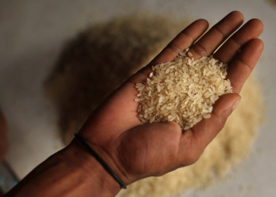 DHAKA, BANGLADESH - JULY 17: A man holds a handful of rice grains at a market in Dhaka. Rice, a staple for Bangladesh's 144 million people, has nearly doubled in price in the past 12 months. (Photo by Spencer Platt/Getty Images)