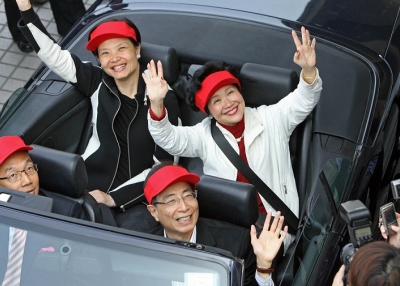 Hong Kong's former top civil servant, Anson Chan (top R), democrats Audrey Eu (top L), Alan Leong (bottom L), and Martin Lee (bottom R) wave to the press the day after Chan won a by-election in Hong Kong on Dec. 3, 2007. (Mike Clarke/AFP/Getty Images)